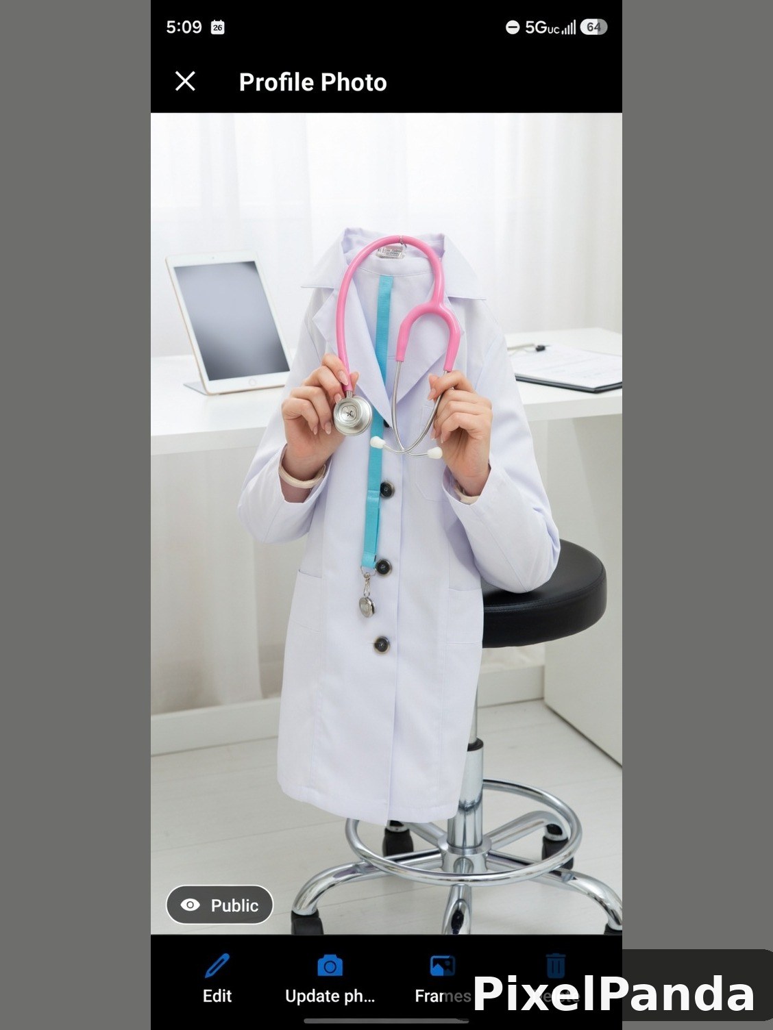 Person in white coat holding pink stethoscope in office setting