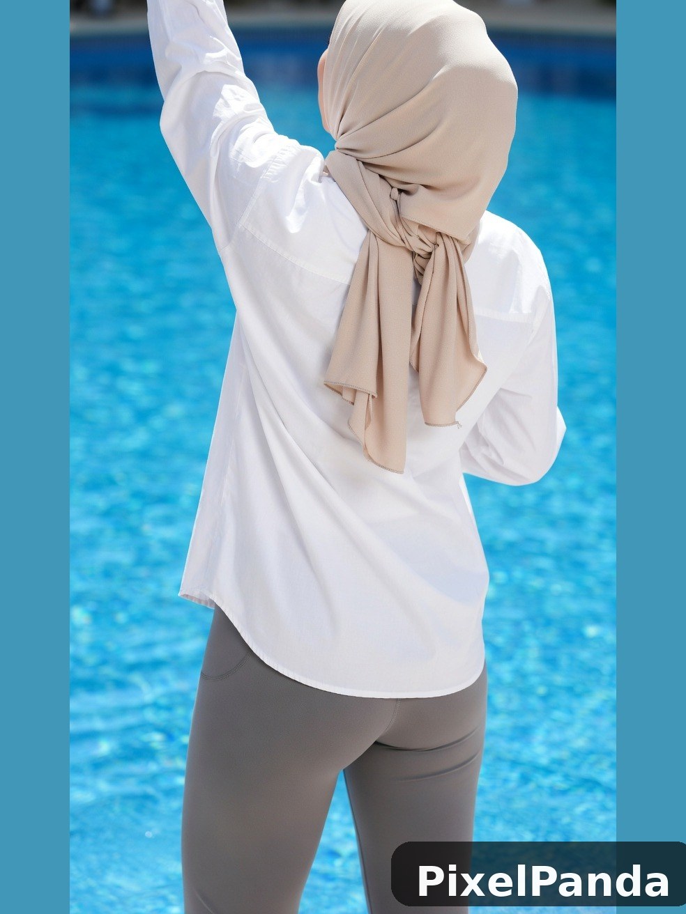 Person in white shirt and beige headwrap by swimming pool