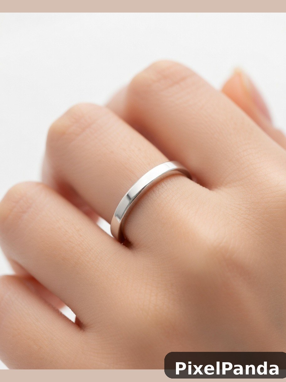 Silver band ring on hand with neutral nail polish