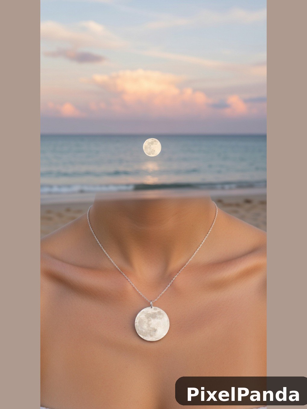 Silver moon pendant necklace worn on beach at sunset