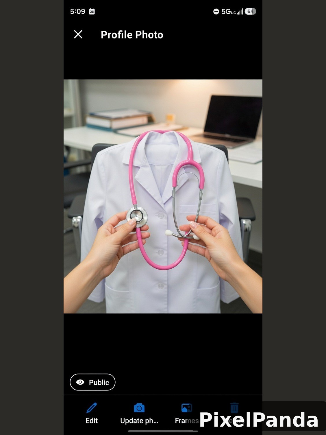 Hands holding pink stethoscope against white medical coat