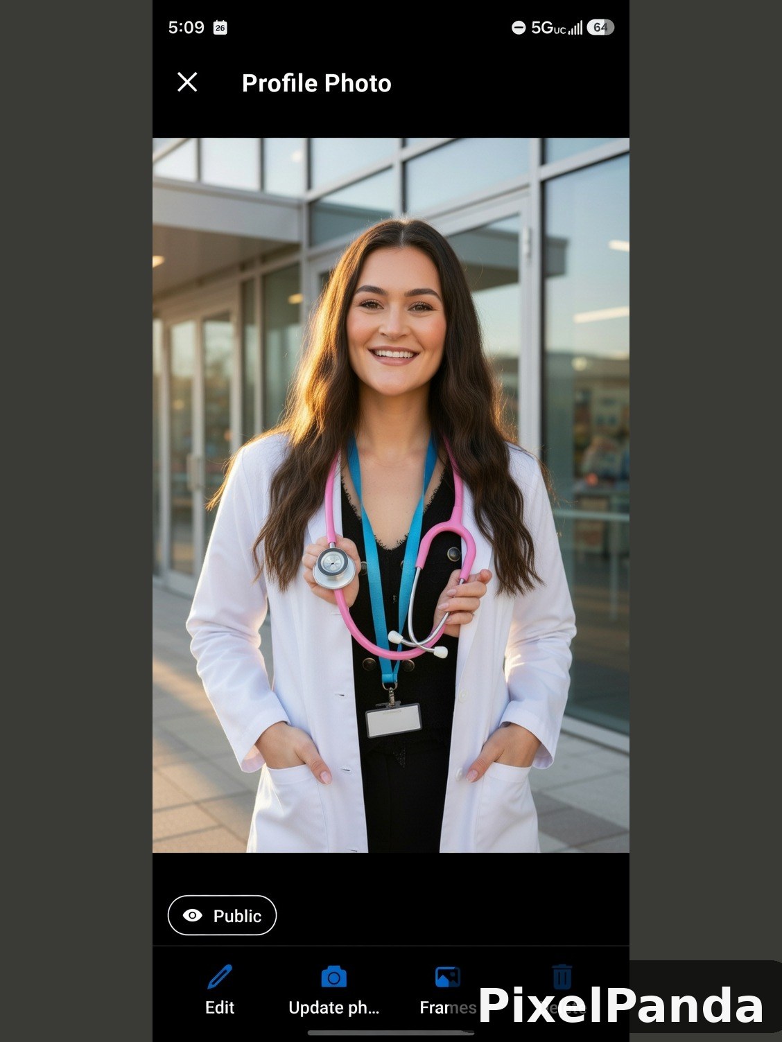 Woman in white lab coat holding pink stethoscope in modern facility