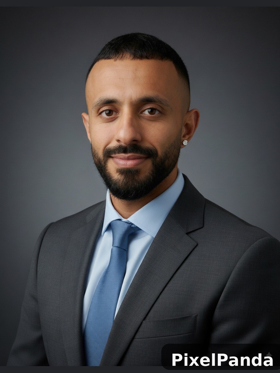 Man with dark beard wearing charcoal suit and blue tie