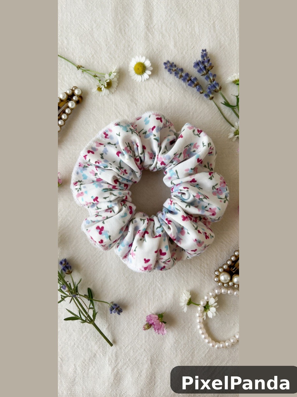 Floral scrunchie surrounded by fresh flowers and pearl beads