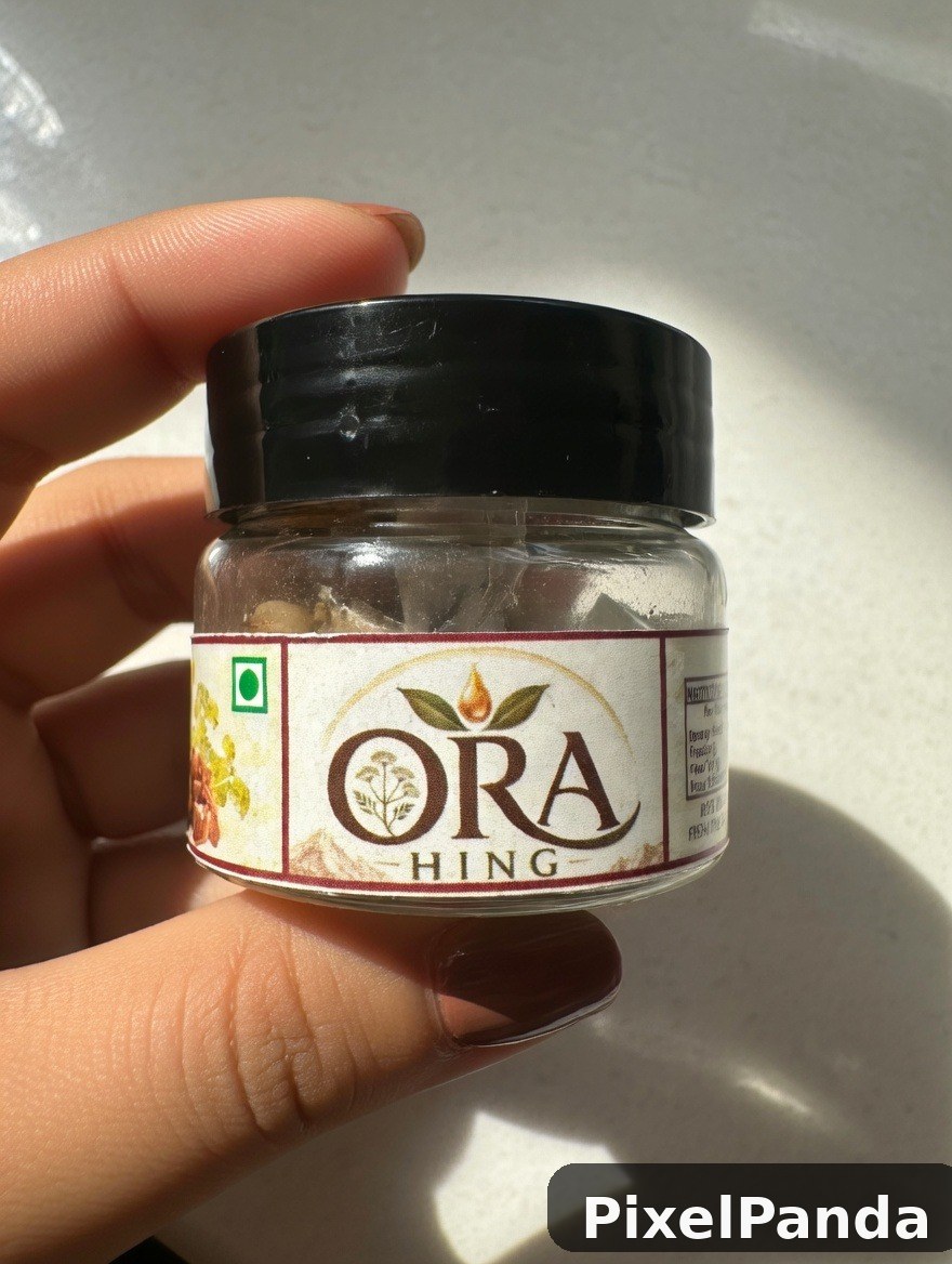 Small jar of Ora Hing spice blend held in hand