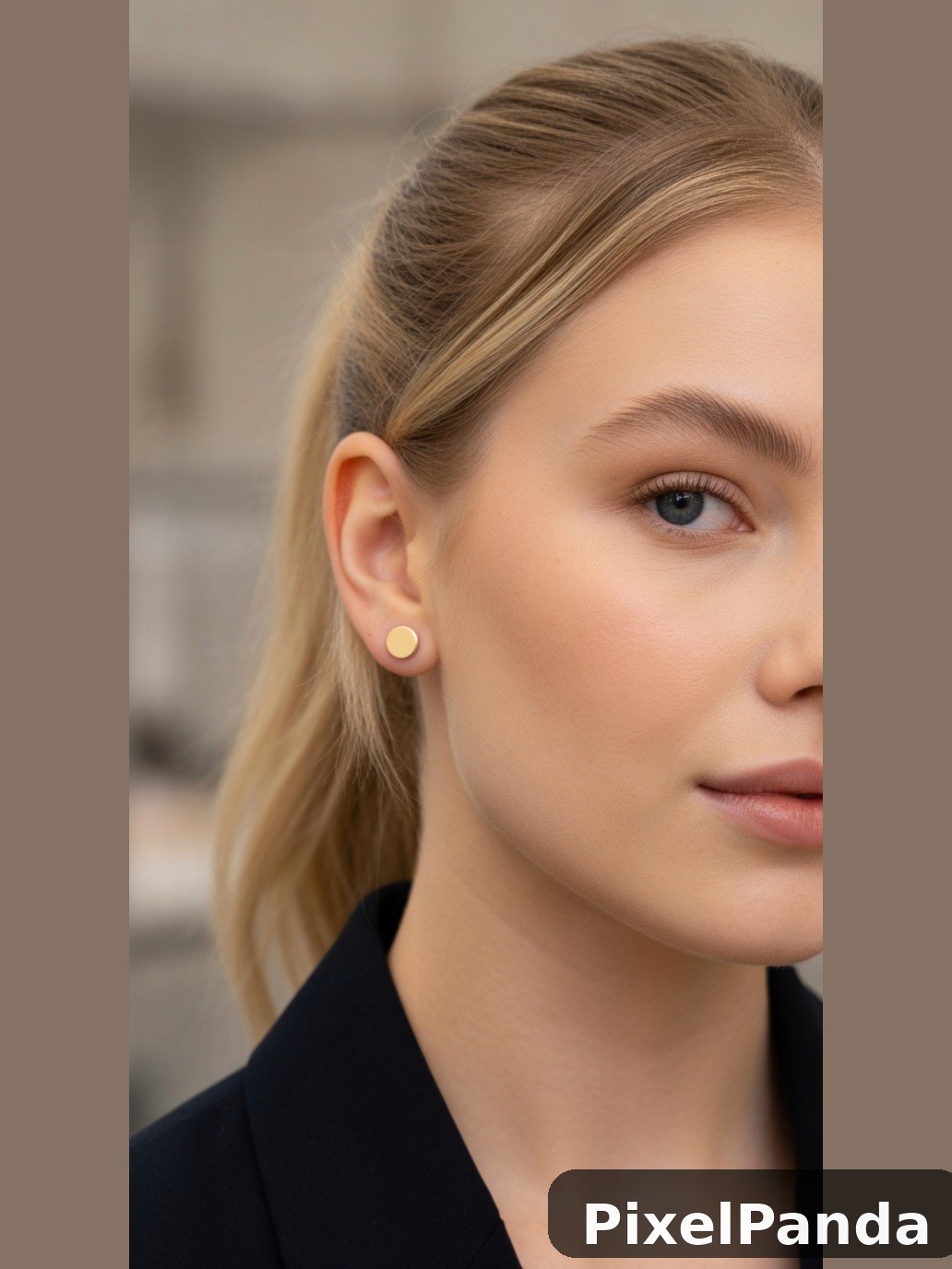 Person with shoulder-length blonde hair wearing gold stud earrings
