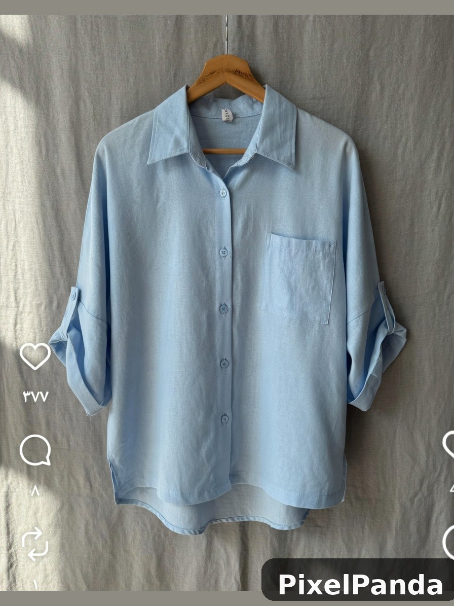 Light blue button-up shirt on wooden hanger against gray wall
