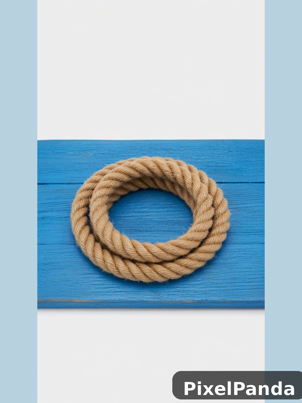 Coiled rope ring on bright blue wooden plank