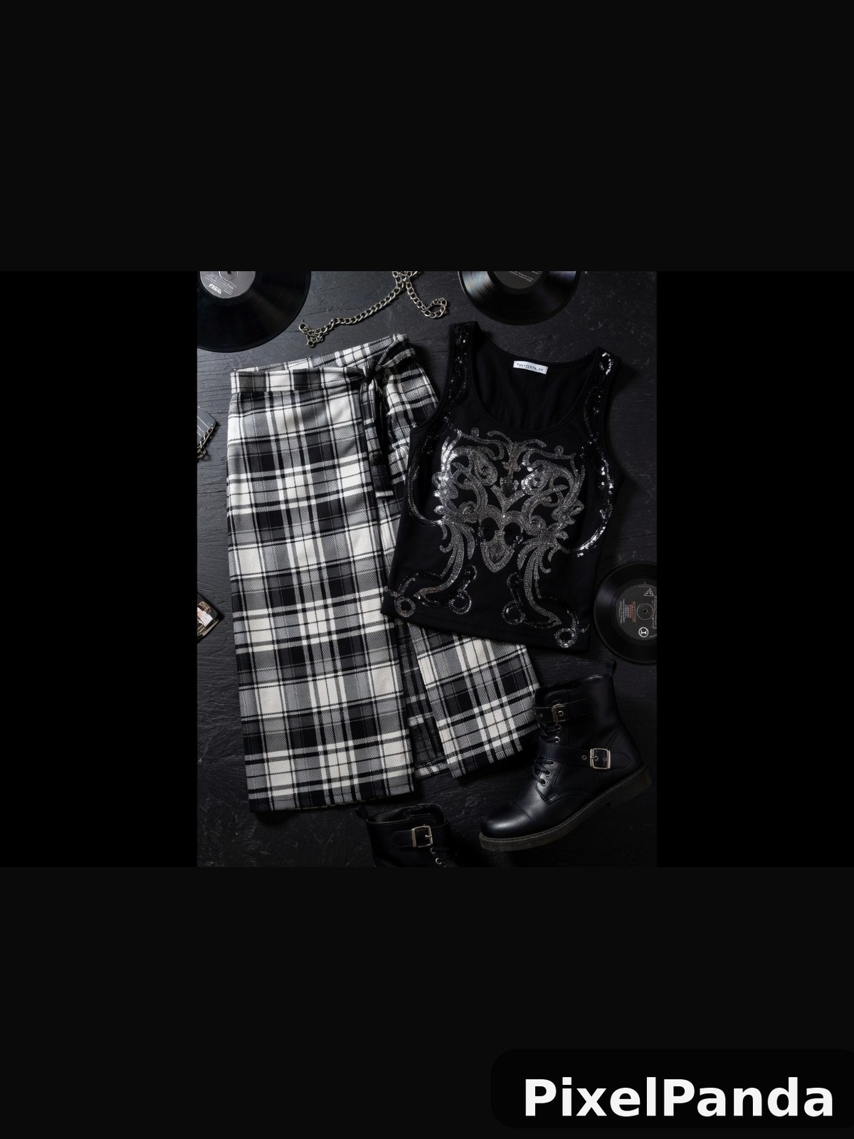 Black and white plaid skirt with ornate embroidered tank top flatlay
