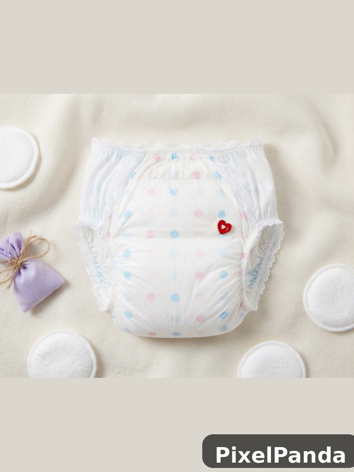 White diaper with pink and blue polka dots and red heart