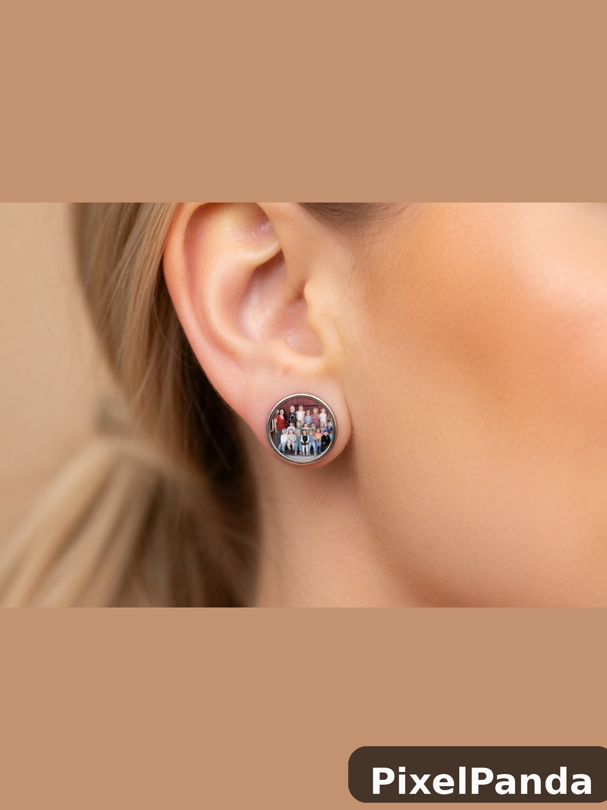 Round silver earring with group photo design on ear