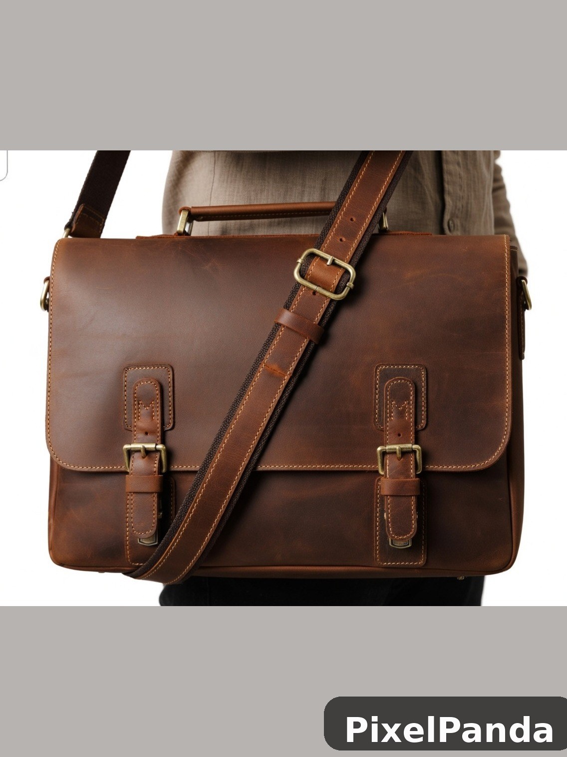 Brown leather messenger bag with brass buckles and stitching