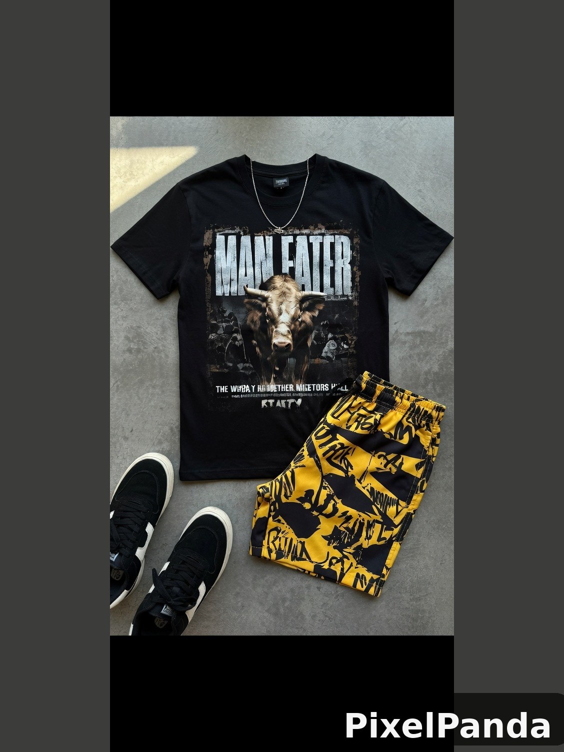 Black Man Eater graphic tee with yellow patterned shorts and sneakers
