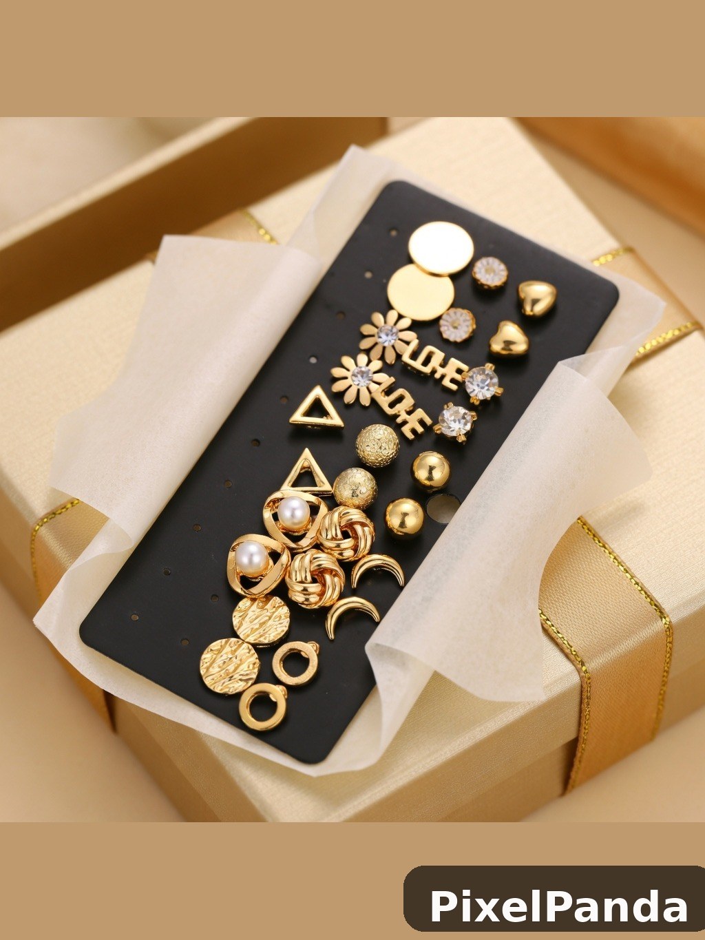 Black display card with gold and pearl jewelry studs in beige gift box