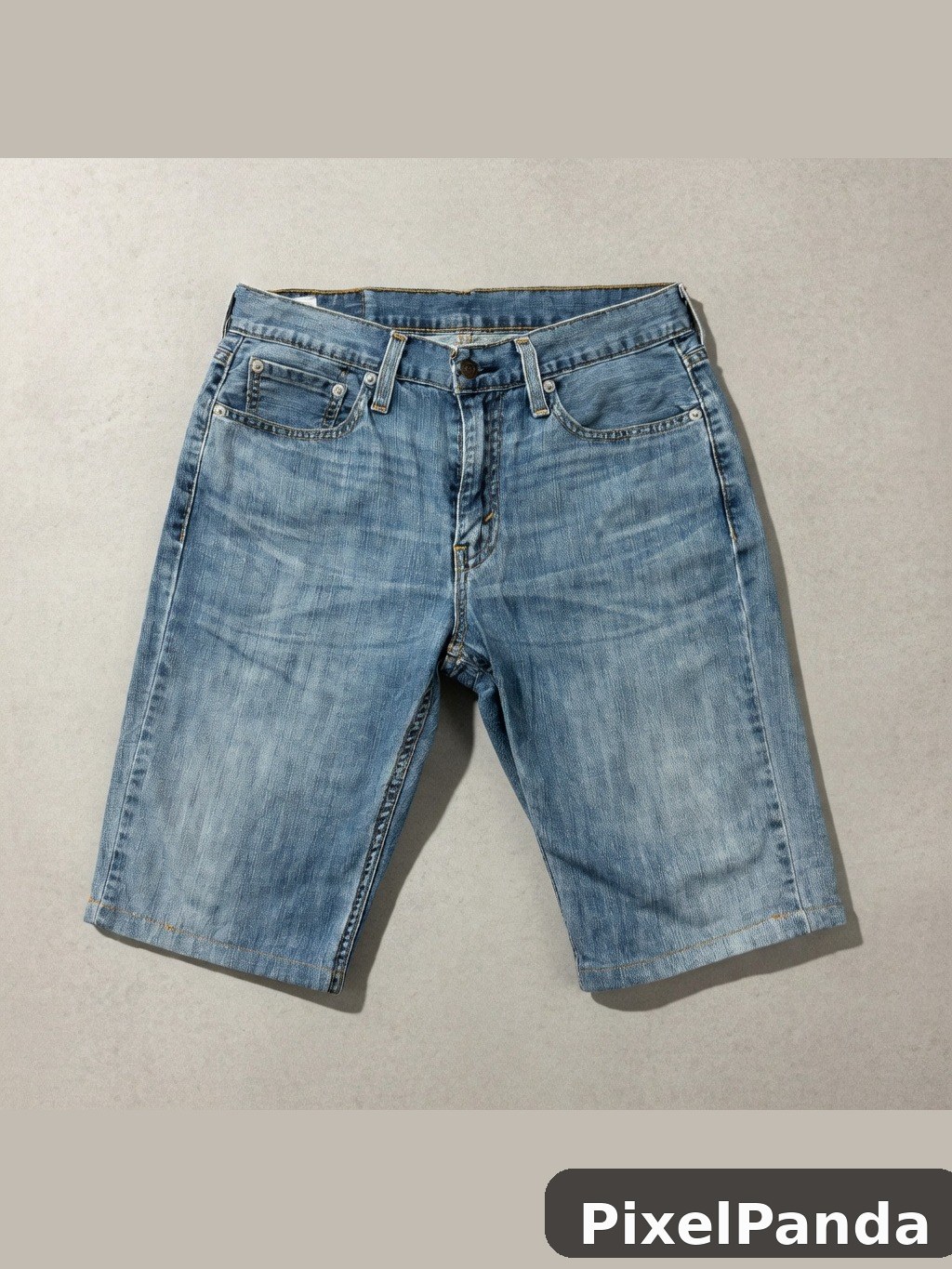 Medium wash denim shorts laid flat on neutral background