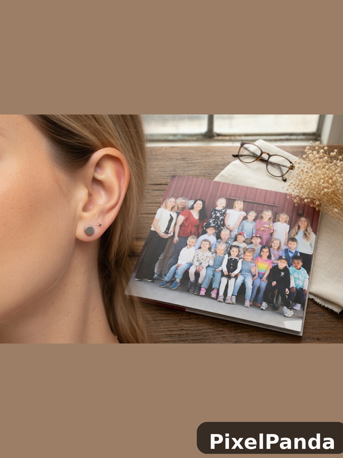 Person wearing small circular stud earrings with family photo display