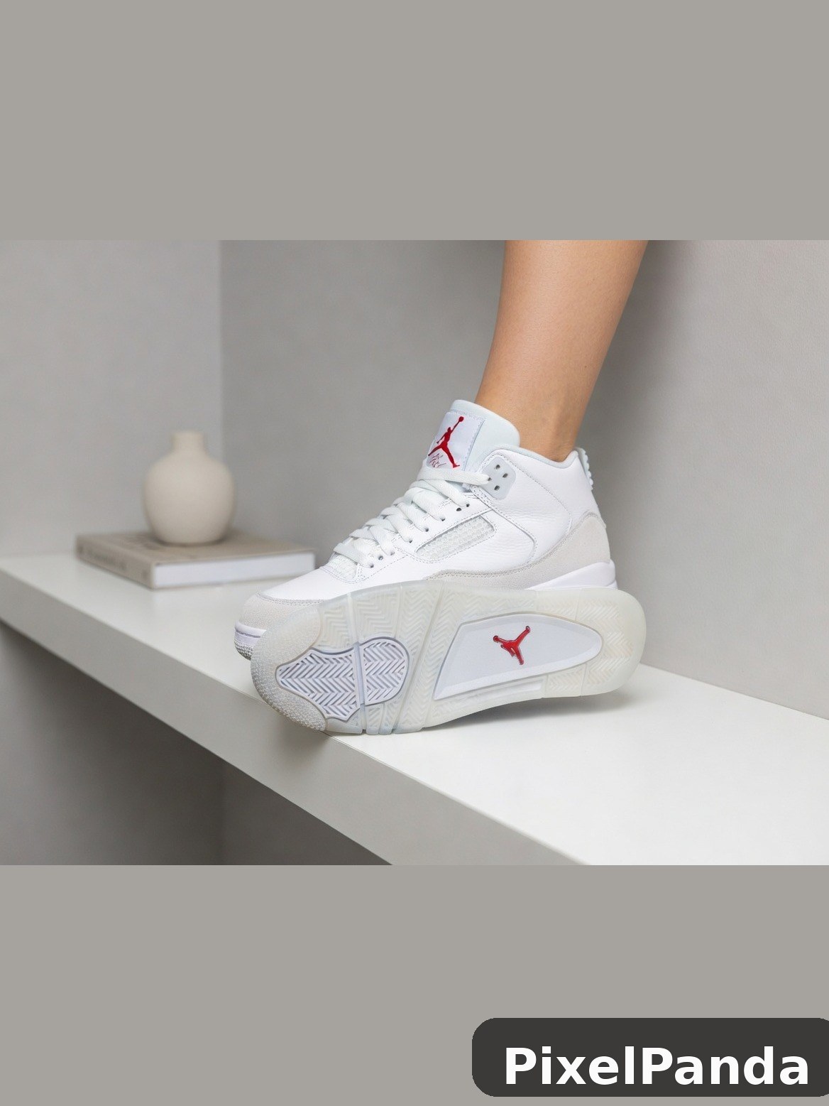 White and red high-top sneaker on minimalist shelf display