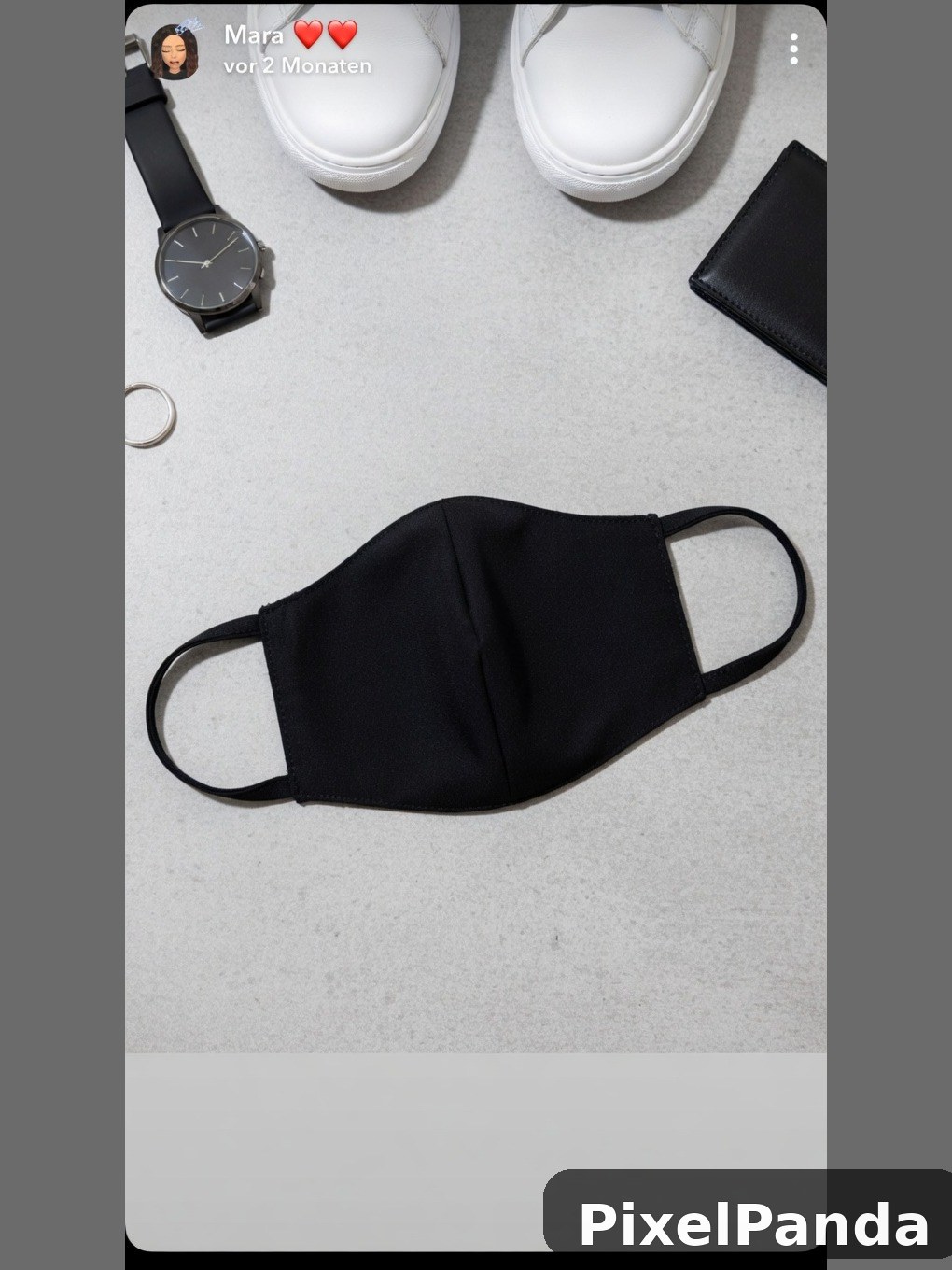 Black fabric face mask with white sneakers and accessories flat lay