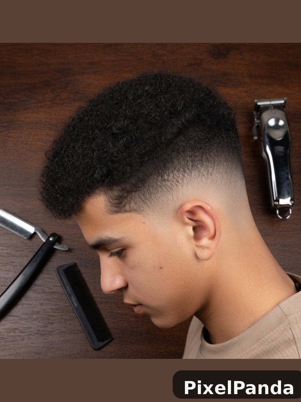 Person with textured fade haircut and professional clippers