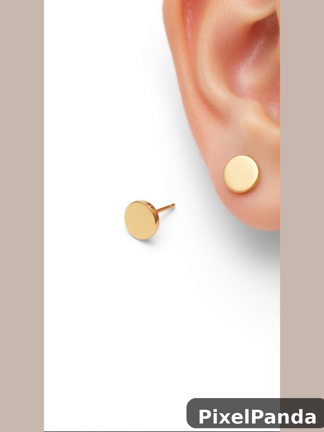 Small gold disc stud earrings on ear with backing post visible