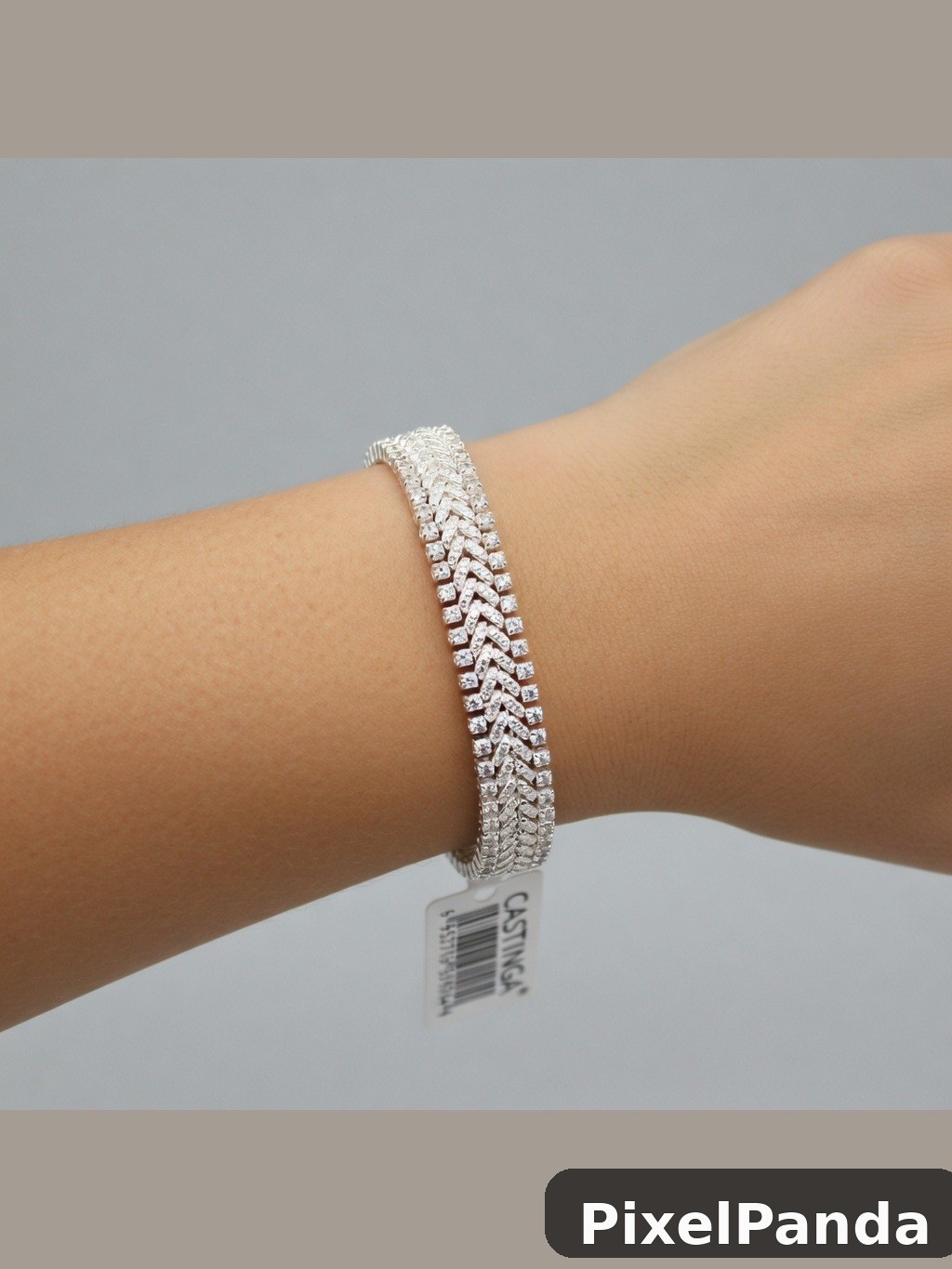 Silver diamond chevron bracelet on wrist with product tag