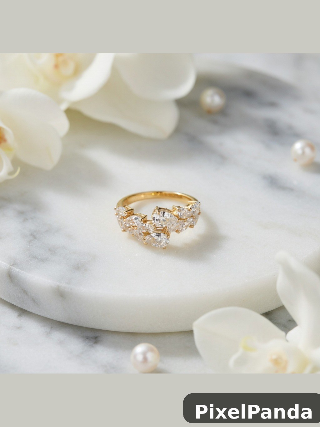 Gold ring with clustered cubic zirconia stones on marble dish