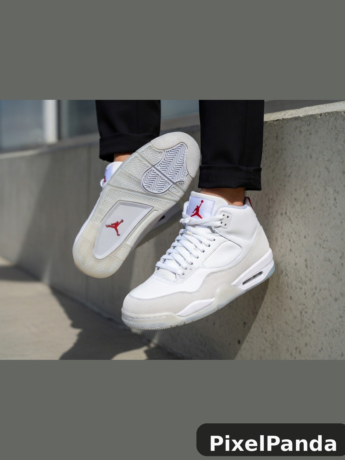 White leather high-top sneakers with red logo and geometric sole