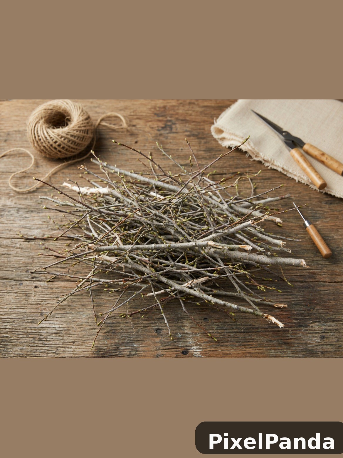 Dried twigs and branches arranged on weathered wood table