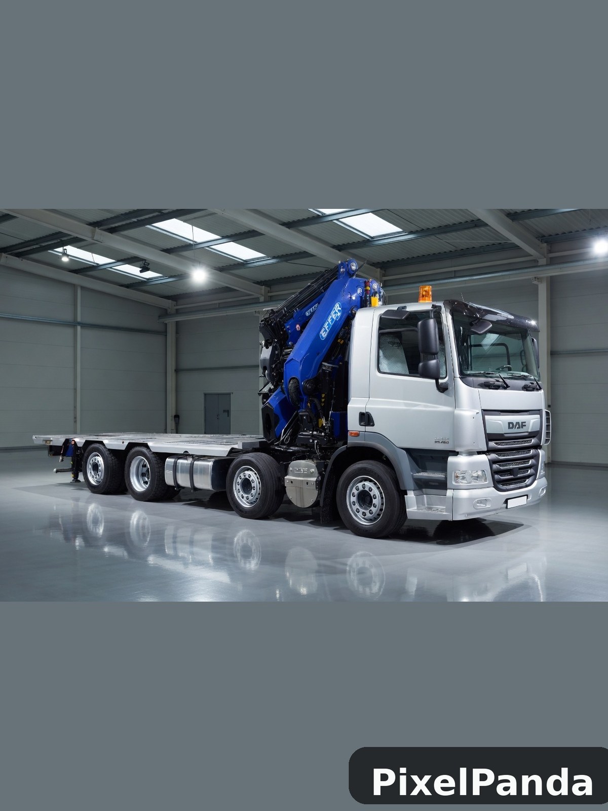 White DAF truck with blue hydraulic crane in industrial warehouse