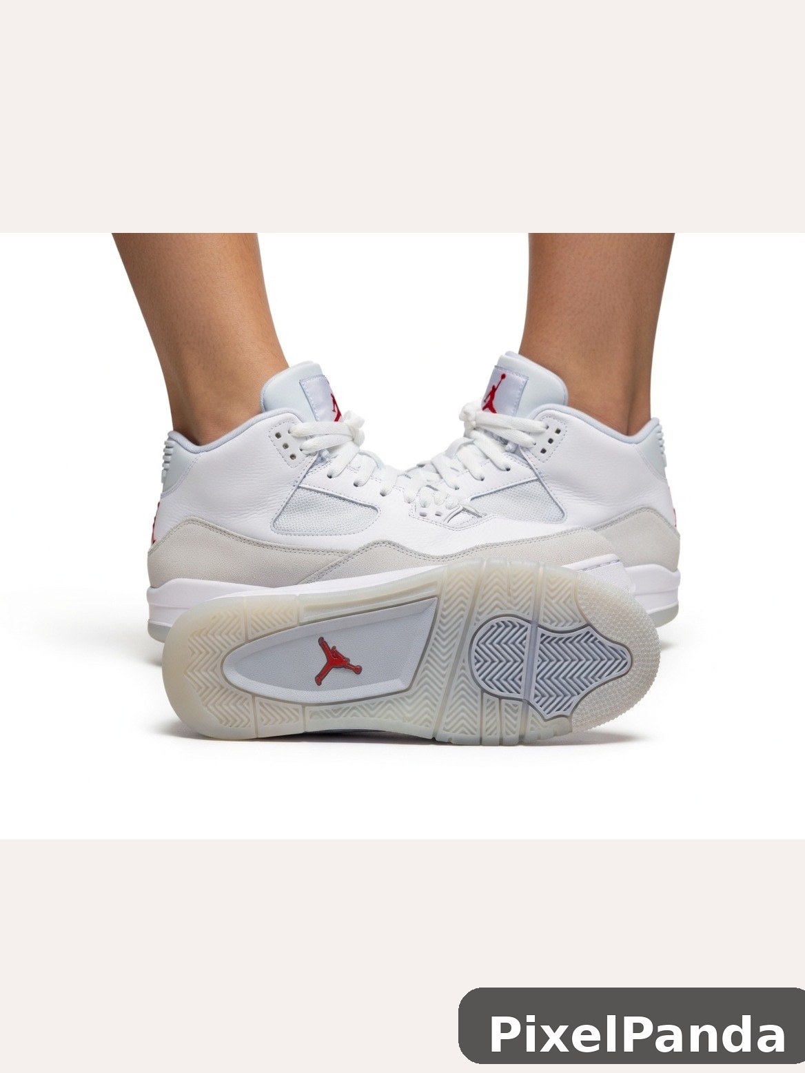 White leather mid-top sneakers with cream and red accents worn on feet