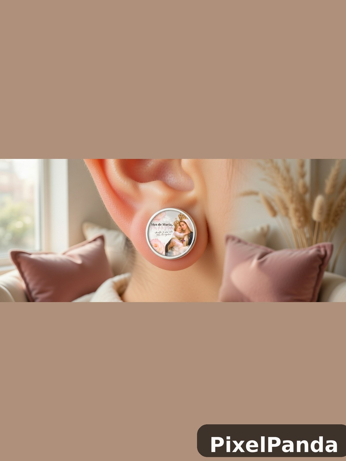 Person wearing round religious medallion earring with portrait image
