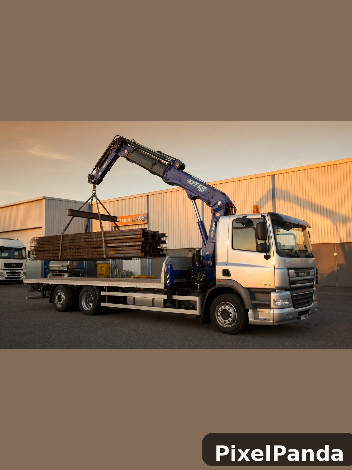 White DAF truck with blue crane lifting steel beams at industrial facility