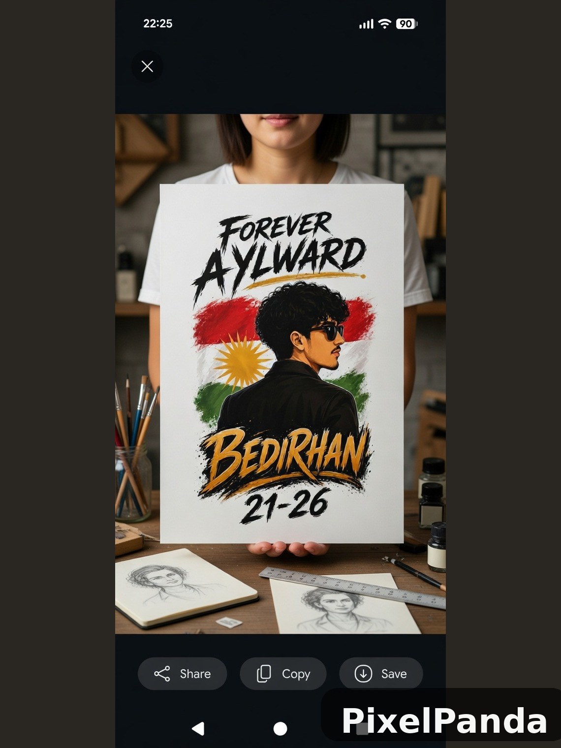 Person holding graphic t-shirt with portrait and Kurdish flag design