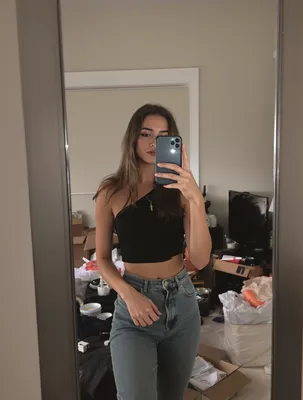 AI-generated portrait of blonde woman taking mirror selfie