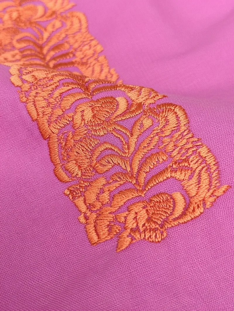 Detail close-up of Embroidered Ruffle Top